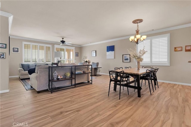 dining area featuring light wood finished floors, baseboards, and crown molding