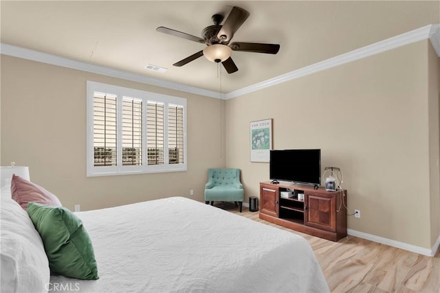 bedroom with baseboards, ornamental molding, and visible vents