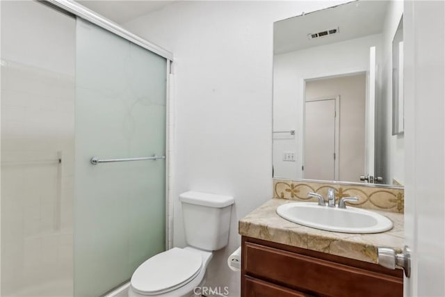 full bathroom with vanity, visible vents, a shower stall, and toilet