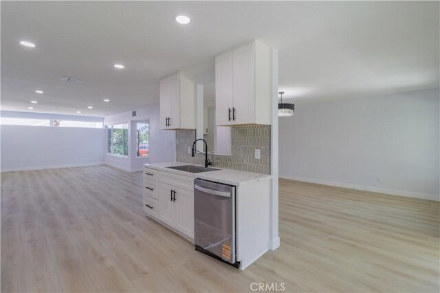 1080 Alta Loma Dr, Corona, CA 92882 - kitchen with dishwasher, open floor plan, a sink, baseboards, and light wood-style floors