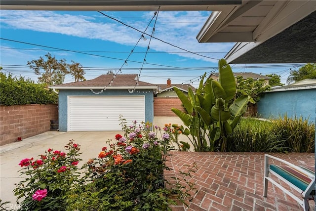 detached garage featuring fence