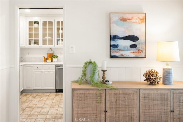 bar featuring dishwasher and wainscoting