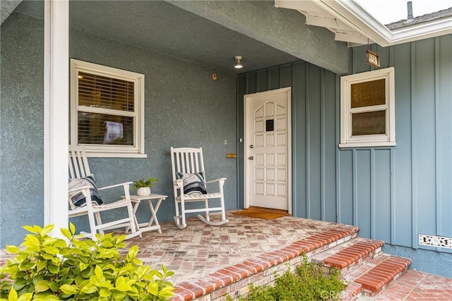 property entrance featuring board and batten siding