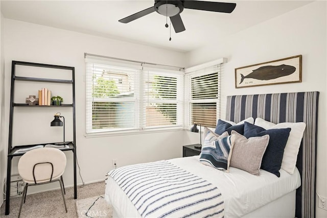 carpeted bedroom with baseboards and ceiling fan