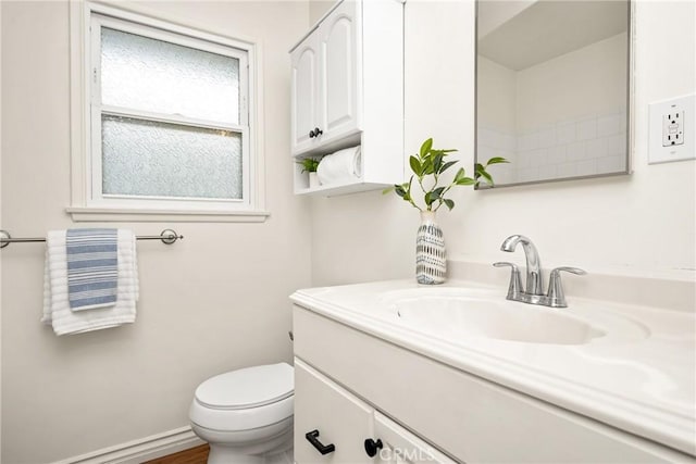 bathroom featuring toilet and vanity
