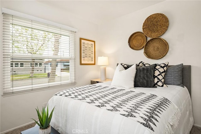 carpeted bedroom featuring baseboards