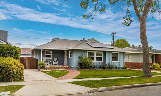 view of front facade featuring a gate, solar panels, board and batten siding, covered porch, and a front yard