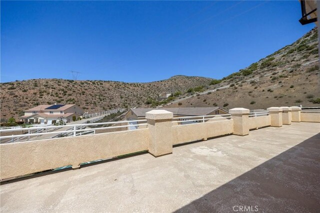view of patio / terrace featuring a mountain view and a balcony