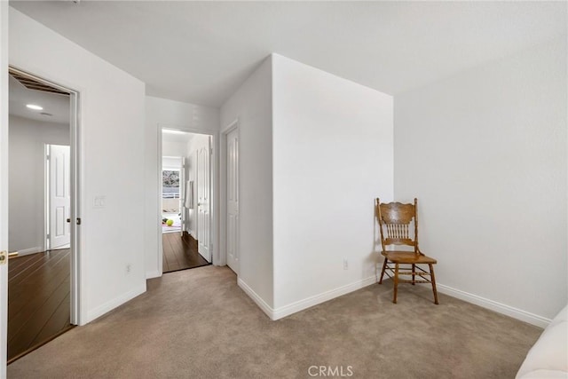 hall with carpet flooring and baseboards