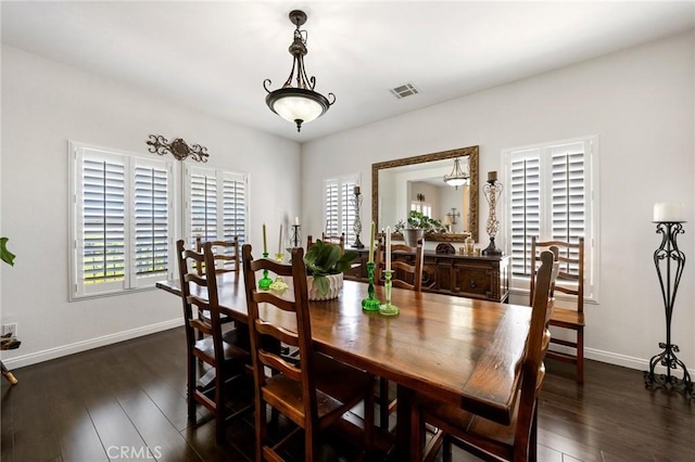 dining area featuring baseboards, dark wood-type flooring, and visible vents