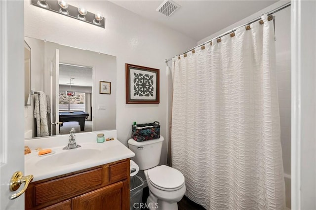 full bathroom with shower / bath combo, visible vents, vanity, and toilet