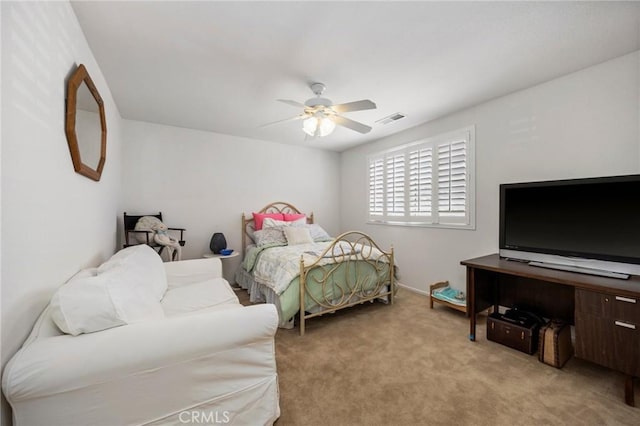 bedroom with light carpet, a ceiling fan, and visible vents