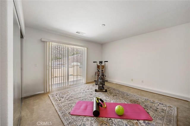 workout area with carpet floors, visible vents, and baseboards