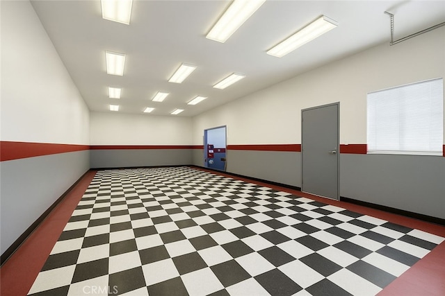 empty room featuring baseboards and tile patterned floors