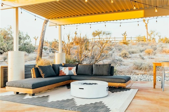 view of patio / terrace with an outdoor living space with a fire pit