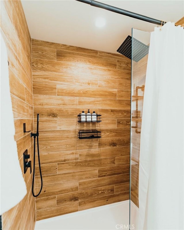 bathroom with a tile shower