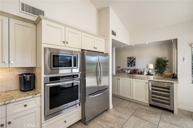 283 Wild Horse Dr, Palm Desert, CA 92211 - kitchen featuring backsplash, appliances with stainless steel finishes, beverage cooler, and visible vents