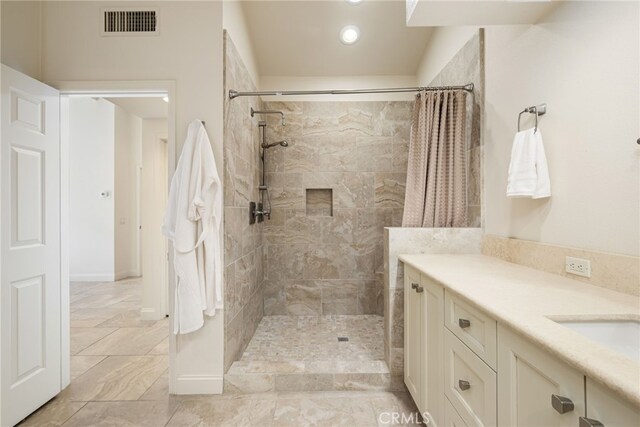 283 Wild Horse Dr, Palm Desert, CA 92211 - full bathroom with recessed lighting, a tile shower, visible vents, and vanity