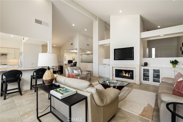 283 Wild Horse Dr, Palm Desert, CA 92211 - living area featuring high vaulted ceiling, a lit fireplace, visible vents, and recessed lighting