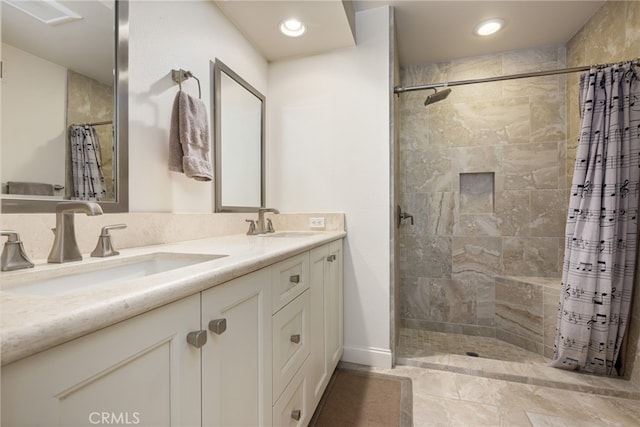 283 Wild Horse Dr, Palm Desert, CA 92211 - bathroom featuring a tile shower, a sink, double vanity, and recessed lighting