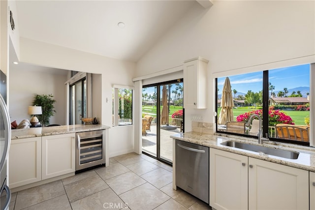 283 Wild Horse Dr, Palm Desert, CA 92211 - kitchen with wine cooler, a sink, white cabinetry, dishwasher, and high vaulted ceiling