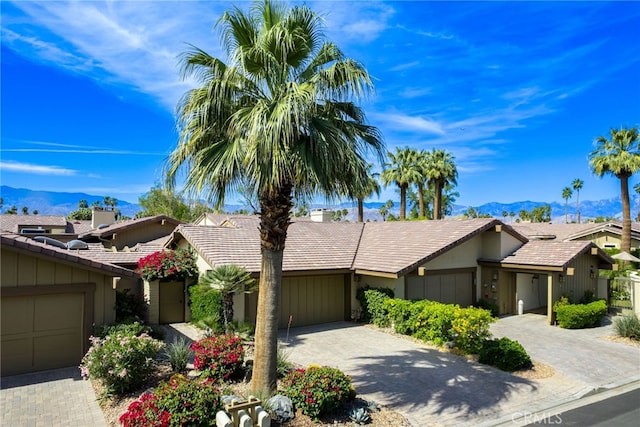 283 Wild Horse Dr, Palm Desert, CA 92211 - single story home with a tile roof, a mountain view, a garage, stucco siding, and decorative driveway