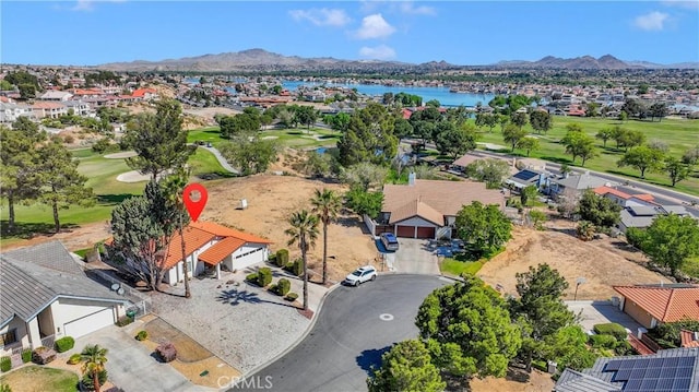birds eye view of property featuring a residential view, view of golf course, and a water and mountain view