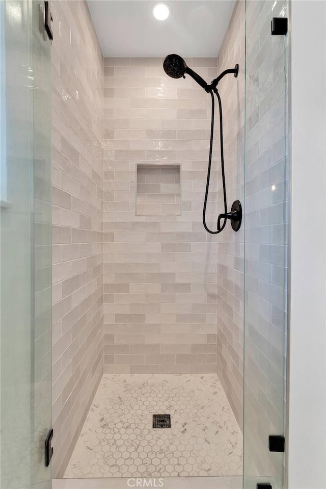 full bathroom featuring recessed lighting and a shower stall