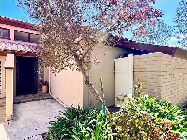 5941 Armaga Spring Rd Unit B, Rancho Palos Verdes, CA 90275 - view of home's exterior with a tile roof, stucco siding, and fence