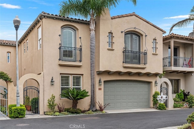 354 Salta Verde Pt, Long Beach, CA 90803 - view of front of home featuring a garage, a tiled roof, stucco siding, a balcony, and driveway