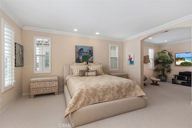 bedroom featuring recessed lighting, carpet, baseboards, ornamental molding, and arched walkways