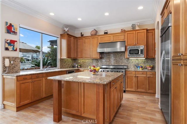 354 Salta Verde Pt, Long Beach, CA 90803 - kitchen featuring brown cabinets, built in appliances, light stone countertops, under cabinet range hood, and a kitchen island