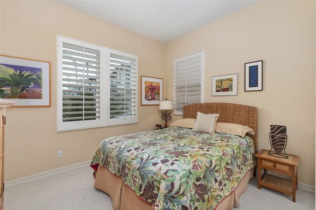 carpeted bedroom with baseboards