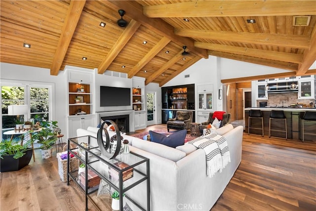 14 Chuckwagon Rd, Rolling Hills, CA 90274 - living area featuring visible vents, wood ceiling, wood finished floors, a fireplace, and vaulted ceiling with beams