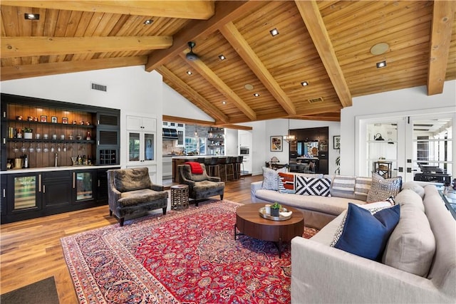 14 Chuckwagon Rd, Rolling Hills, CA 90274 - living room with lofted ceiling with beams, visible vents, wooden ceiling, light wood-style flooring, and a bar