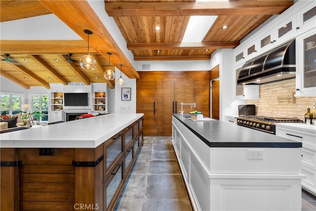 14 Chuckwagon Rd, Rolling Hills, CA 90274 - kitchen with a spacious island, under cabinet range hood, decorative backsplash, beamed ceiling, and wood ceiling
