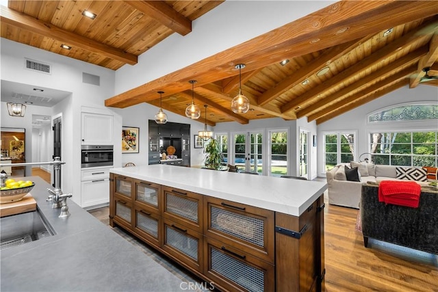 14 Chuckwagon Rd, Rolling Hills, CA 90274 - kitchen featuring oven, visible vents, dark wood finished floors, wooden ceiling, and vaulted ceiling with beams
