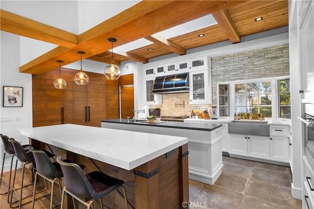 14 Chuckwagon Rd, Rolling Hills, CA 90274 - kitchen with a center island, white cabinetry, extractor fan, beamed ceiling, and tasteful backsplash