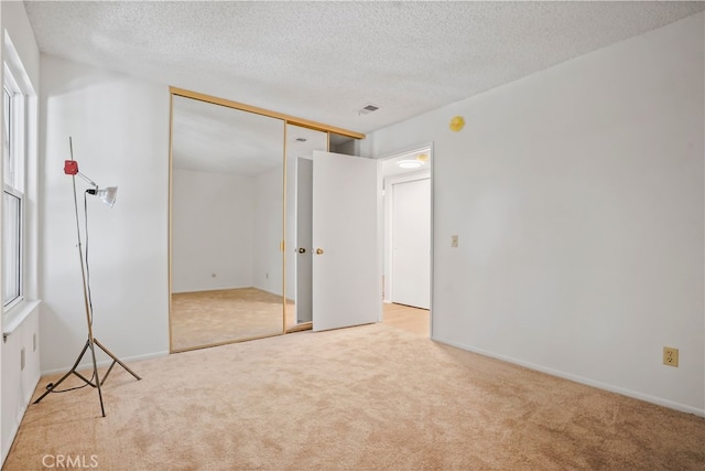 7050 Shoup Ave Unit 173, Canoga Park, CA 91303 - unfurnished bedroom with carpet flooring, a textured ceiling, and visible vents