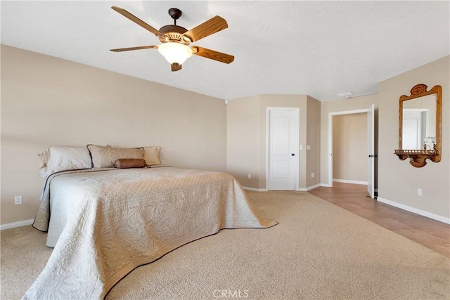 bedroom with carpet flooring, baseboards, and a ceiling fan
