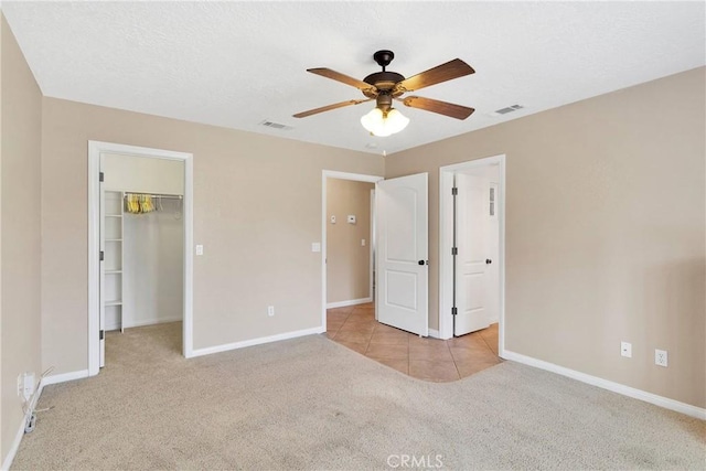 unfurnished bedroom featuring baseboards, visible vents, and carpet
