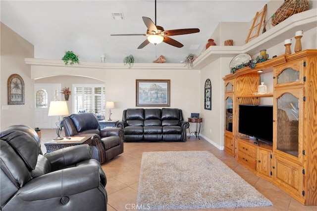 living area with a high ceiling, a ceiling fan, visible vents, and light tile patterned floors