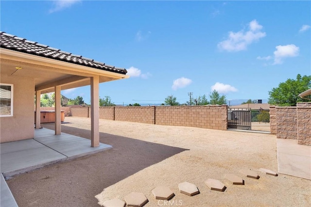 view of yard with a gate, fence, and a patio area