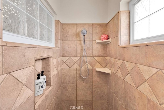 bathroom with a tile shower