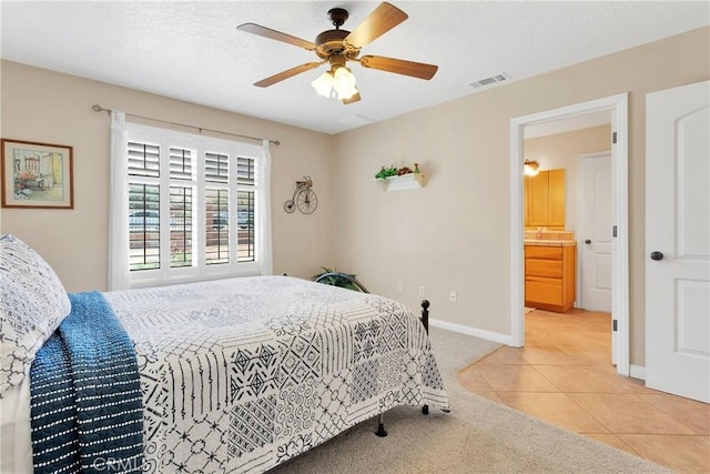 bedroom with light carpet, baseboards, visible vents, ceiling fan, and light tile patterned floors