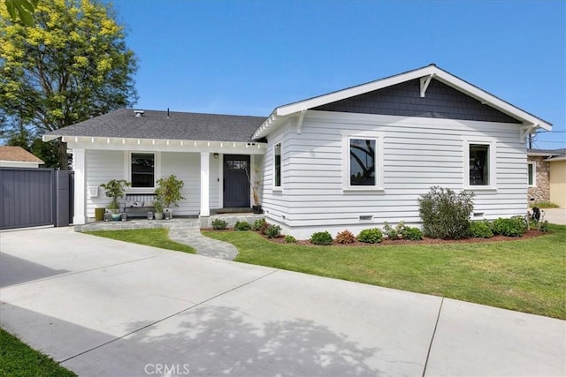 single story home featuring a porch and a front lawn