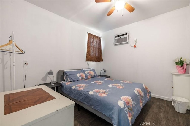 bedroom featuring baseboards, a ceiling fan, wood finished floors, and an AC wall unit