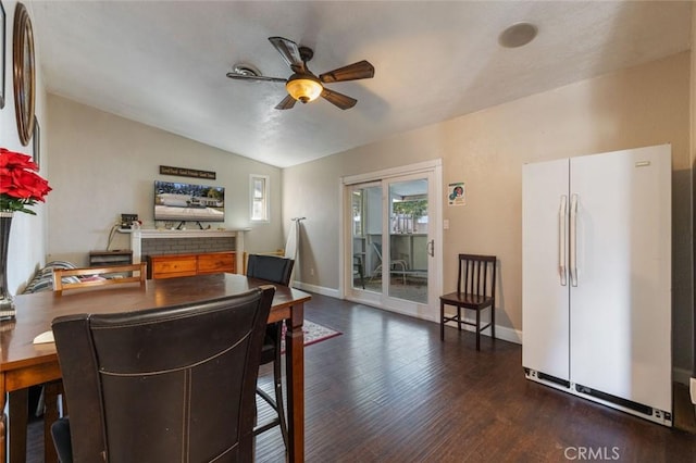 dining area with baseboards, vaulted ceiling, wood finished floors, and ceiling fan