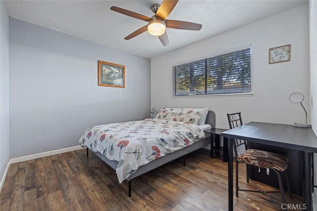 bedroom with baseboards, wood finished floors, and ceiling fan