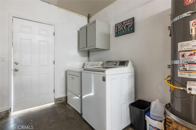laundry room featuring cabinet space, washer and dryer, and strapped water heater